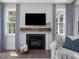 Living room features a fireplace with a wooden mantle and a television above at 1148 Tringham Ct, Apex, NC 27502