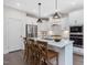 Bright kitchen features a kitchen island with pendant lighting and stainless steel appliances at 1148 Tringham Ct, Apex, NC 27502