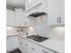 Bright kitchen features white cabinets, granite countertops, and a gas cooktop at 1148 Tringham Ct, Apex, NC 27502