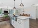 Bright kitchen island features a stainless steel sink and modern lighting at 1148 Tringham Ct, Apex, NC 27502