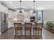 Bright kitchen features a kitchen island with pendant lighting and stainless steel appliances at 1148 Tringham Ct, Apex, NC 27502