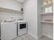 Well-organized laundry room with washer, dryer, and ample shelving at 1148 Tringham Ct, Apex, NC 27502