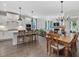 Open-concept kitchen, dining, and living area with ample seating and modern finishes at 1148 Tringham Ct, Apex, NC 27502
