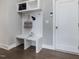 Mudroom with built-in bench, hooks, and storage cabinets at 1148 Tringham Ct, Apex, NC 27502