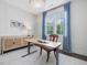 Well-lit office featuring a sit stand desk, blue curtains, and natural light at 1148 Tringham Ct, Apex, NC 27502