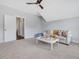 Spacious playroom features a ceiling fan, white couch, and room for activities at 1148 Tringham Ct, Apex, NC 27502