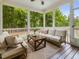 Screened in porch with comfortable seating, ceiling fan, and wooded view at 1148 Tringham Ct, Apex, NC 27502