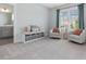 Spacious sitting area with plush seating and natural light from a window at 1148 Tringham Ct, Apex, NC 27502