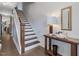 Staircase with hardwood steps, a white railing, and a stylish table with decor at 1148 Tringham Ct, Apex, NC 27502