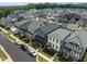 Aerial view of a neighborhood showcasing well-maintained homes, landscaping, and street parking at 117 Banning Dr, Pittsboro, NC 27312