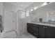 Modern bathroom with double vanity, marble countertops, and tiled shower at 117 Banning Dr, Pittsboro, NC 27312