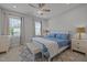 Comfortable bedroom with large windows, ceiling fan, and neutral décor at 117 Banning Dr, Pittsboro, NC 27312