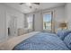 Well-lit bedroom with large windows and a view of a neighboring house at 117 Banning Dr, Pittsboro, NC 27312