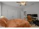 Bedroom with a desk, rolling chair, two large windows, and dual closets at 117 Banning Dr, Pittsboro, NC 27312