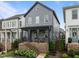 View of the gray two-story home with a welcoming porch and a manicured front yard at 117 Banning Dr, Pittsboro, NC 27312