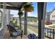 View from the front porch showing cozy seating and hanging plants overlooking the neighborhood street at 117 Banning Dr, Pittsboro, NC 27312
