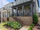 Home's front yard with landscaped garden featuring hydrangea bushes and covered front porch with seating at 117 Banning Dr, Pittsboro, NC 27312