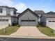 Exterior view of a gray detached garage in a modern neighborhood, with tidy landscaping and a concrete driveway at 117 Banning Dr, Pittsboro, NC 27312