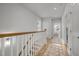 Bright hallway features hardwood floors, white trim, and natural light from the window at 117 Banning Dr, Pittsboro, NC 27312
