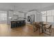 Bright kitchen with white cabinets, stainless steel appliances, an island with seating, and a dining area at 117 Banning Dr, Pittsboro, NC 27312