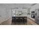 Bright kitchen with white cabinets, stainless steel appliances, and a large island with barstool seating at 117 Banning Dr, Pittsboro, NC 27312