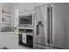 Close up of a bright kitchen featuring stainless steel appliances, white cabinets, and counter with coffee bar at 117 Banning Dr, Pittsboro, NC 27312