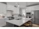 Bright kitchen with white cabinets, stainless steel appliances, and a large island with a sink at 117 Banning Dr, Pittsboro, NC 27312