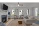 Inviting living room featuring a cozy fireplace, ceiling fan, and neutral furnishings for a comfortable atmosphere at 117 Banning Dr, Pittsboro, NC 27312