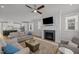 Bright living room with a fireplace, hardwood floors, and view into a modern kitchen at 117 Banning Dr, Pittsboro, NC 27312