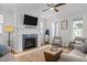 Inviting living room featuring a cozy fireplace, ceiling fan, and neutral furnishings for a comfortable atmosphere at 117 Banning Dr, Pittsboro, NC 27312