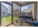 Cozy screened-in porch with comfortable seating and a view of the backyard at 117 Banning Dr, Pittsboro, NC 27312