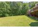 A expansive green backyard with mature trees, offering a serene outdoor space at 117 Carolina Forest Rd, Chapel Hill, NC 27516