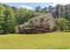 Spacious backyard featuring a large yellow home with a deck and screened porch at 117 Carolina Forest Rd, Chapel Hill, NC 27516