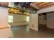 Partially finished basement with exposed ducts, concrete flooring, and a small sink at 117 Carolina Forest Rd, Chapel Hill, NC 27516