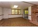 Finished basement area with a brick fireplace, and a view to the staircase to the upper floor at 117 Carolina Forest Rd, Chapel Hill, NC 27516