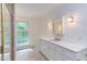 Bright bathroom with a large vanity, tile flooring, and a window view at 117 Carolina Forest Rd, Chapel Hill, NC 27516