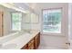 Bathroom with dual sinks and windows bringing in natural light at 117 Carolina Forest Rd, Chapel Hill, NC 27516