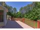 A large wooden deck boasts stained railings and trees in background at 117 Carolina Forest Rd, Chapel Hill, NC 27516