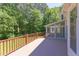 Large wooden deck boasts stained railings and trees in background at 117 Carolina Forest Rd, Chapel Hill, NC 27516