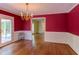 Charming dining room with wainscoting, wood floors, and a vintage chandelier at 117 Carolina Forest Rd, Chapel Hill, NC 27516
