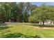 Large lot with detached two-car garage and circle driveway, surrounded by mature trees and landscaping at 117 Carolina Forest Rd, Chapel Hill, NC 27516