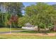 Spacious driveway leads to detached two-car garage, accented by mature trees and manicured lawn at 117 Carolina Forest Rd, Chapel Hill, NC 27516