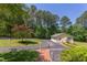 Overhead view of exterior with two-car garage, large driveway, and lush greenery in a park-like setting at 117 Carolina Forest Rd, Chapel Hill, NC 27516