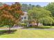 Two-story yellow home with a charming front porch and well-manicured lawn at 117 Carolina Forest Rd, Chapel Hill, NC 27516