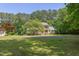 Beautiful yellow house with double porches and lush landscaping on a large green lawn at 117 Carolina Forest Rd, Chapel Hill, NC 27516