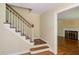 Entryway with hardwood floors, staircase, and doorway to the living room with a cozy fireplace at 117 Carolina Forest Rd, Chapel Hill, NC 27516