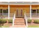 Charming front porch with white railings, brick steps, and flower planters at 117 Carolina Forest Rd, Chapel Hill, NC 27516