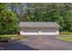 Spacious detached garage with multiple bays and paved driveway at 117 Carolina Forest Rd, Chapel Hill, NC 27516