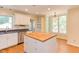 Bright kitchen with island, stainless steel appliances and view to deck at 117 Carolina Forest Rd, Chapel Hill, NC 27516