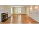 Bright living room featuring hardwood floors, fireplace, and classic wall molding at 117 Carolina Forest Rd, Chapel Hill, NC 27516
